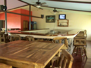 The horseshoe bar is ringed by custom-made oversize bar stools topped by swiveling chairs.